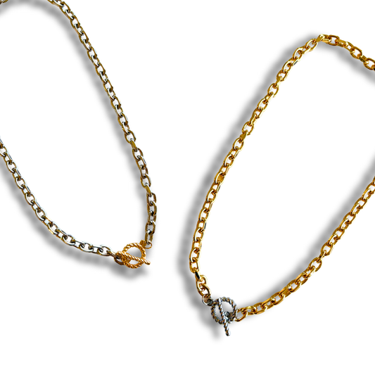 Two necklaces, one gold, one siver, with toggle clasps on a white background