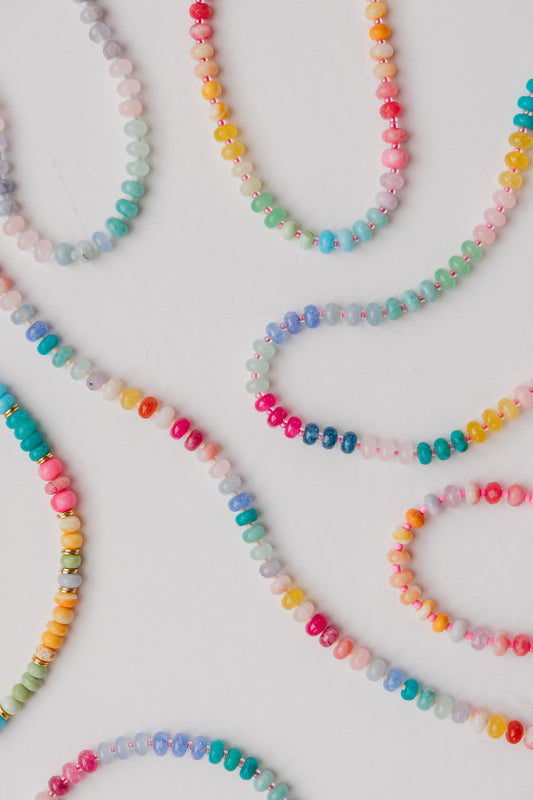 Colorful beaded necklaces on a white background