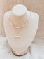 Two necklaces on a mannequin bust against a neutral background