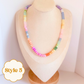 Pastel Colorful gemstone beaded necklace on a mannequin bust.
